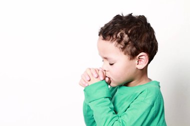 little boy praying with hands together stock photo