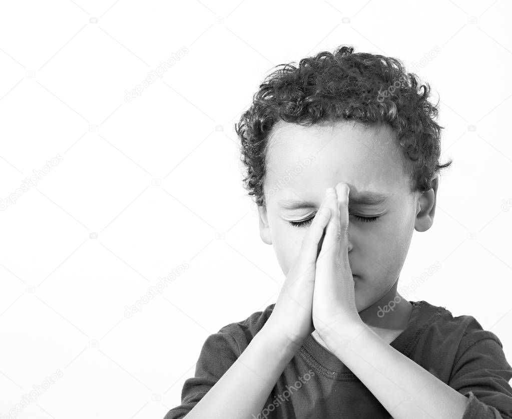 little boy praying to God stock image with hands held together stock photo