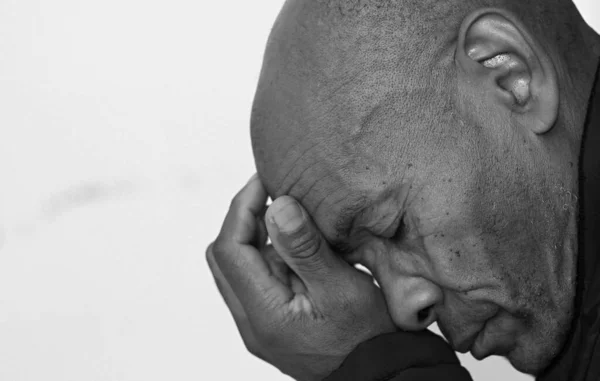 black man praying to god with black grey background