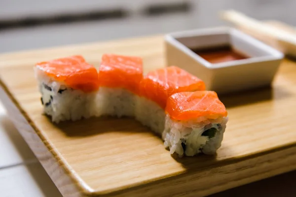 Japanese traditional rolls served in a sushi bar on a wooden tray. Sushi menu. Japanese food concept