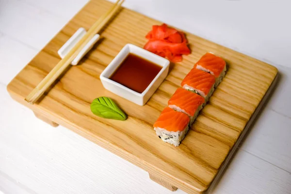 Japanese traditional rolls served in a sushi bar on a wooden tray. Sushi menu. Japanese food concept