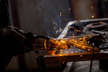 Erkek işçi araba egzoz boru kaynak makinesi ile kısayollarımı koruyucu eldivenler