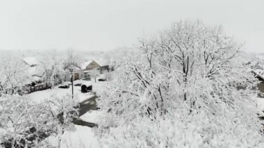 Köy dron 4k hava görüntülerini karla kaplı. Beyaz bulutlu kış hava.