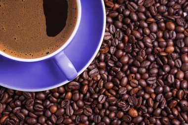 Kahve kahve çekirdekleri ile çevrili masada mor Kupası