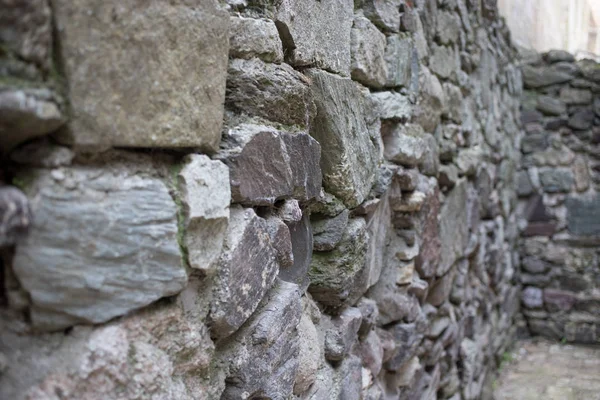 Close up of various shaped stone wall of medieval fortress. — Stock Photo, Image