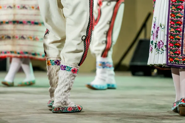 Geleneksel folklorik kostümlü genç Romen dansçının bacaklarındaki yün çorapları kapatın. Romanya Folkloru — Stok fotoğraf