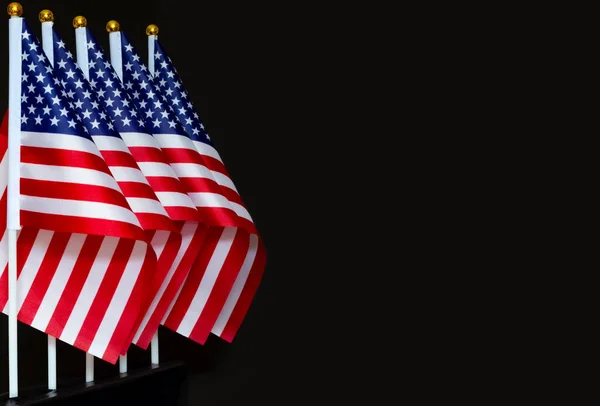 Desktop flags of USA on black background in a straight line with copy space, concept of the patriotic holidays — Stock Photo, Image