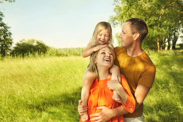 Happy playing family outdoors — Stock Photo, Image