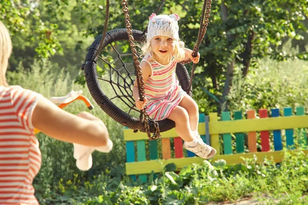 Little girl swinging on a swing — Stock Photo, Image