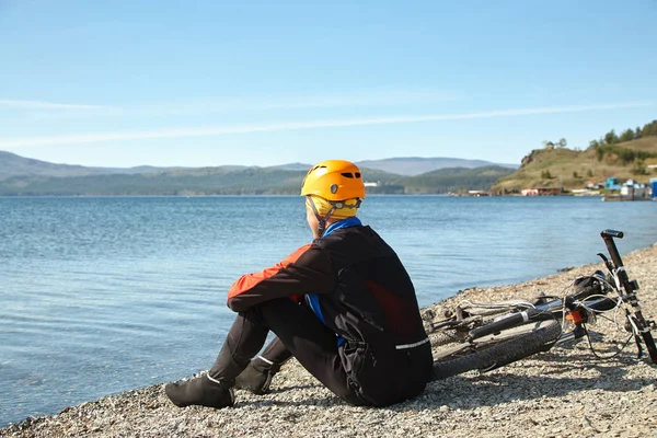 Ciclista sulla riva di un lago di montagna — Foto Stock