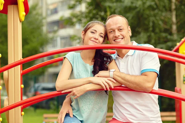 Young happy couple in love outdoors in a summer park — Stock Photo, Image