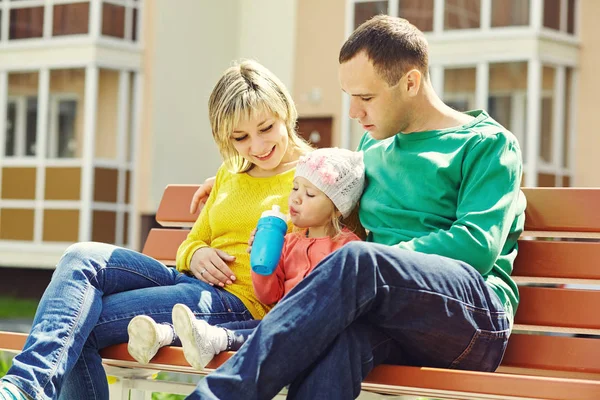 Buitenshuis en gelukkige familie. jonge ouders met baby voor een wandeling in de zomer. Moeder, vader en kind — Stockfoto