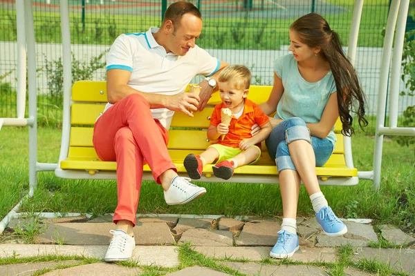 Mom, dad and child eating ice cream