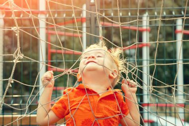 futbol kapısı bir ızgara ile oyun alanında komik küçük çocuk
