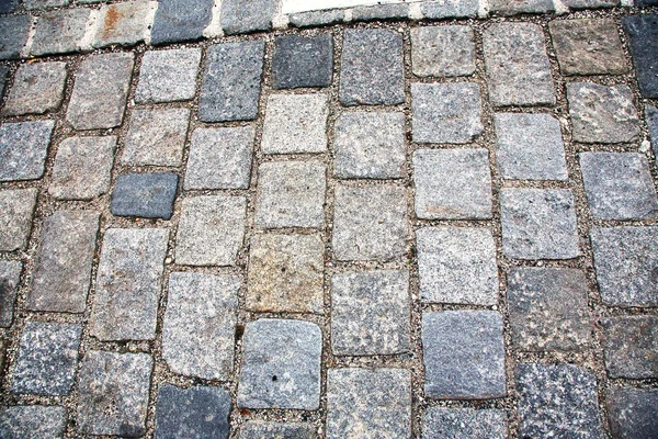 Road paved with paving stones. Cobbles background. — Stock Photo, Image