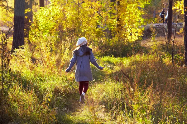 Kävelevä tyttö takki ja baskeri syksyllä — kuvapankkivalokuva