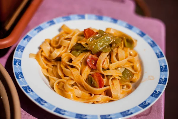 Tagliatelle with pepper and tomato sauce. Royalty Free Stock Photos