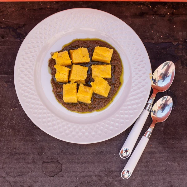 Polenta cubes with olive sauce. — Stock Photo, Image