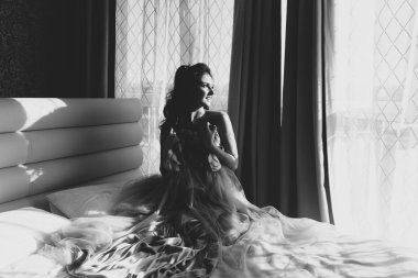 Bir gelinlik pencerenin yakınındaki bir sevimli gelin portresi. Düğün sabah