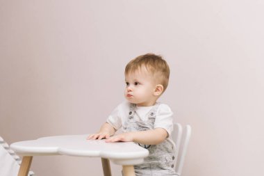 Şirin bebek kreş parlak renklerde bir bulut şeklinde masada oturan.