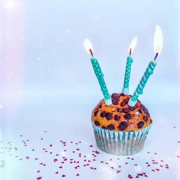 Happy birthday background - birthday cupcake with burning candle. Holidays greeting card