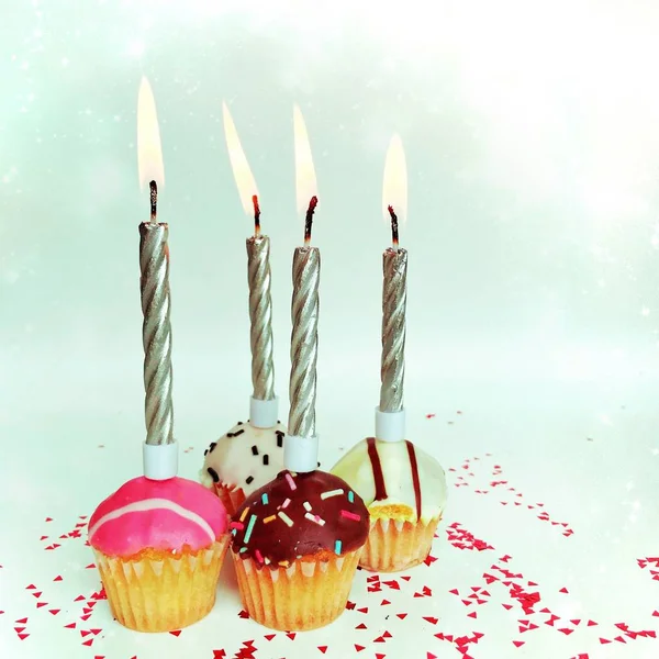 Happy birthday background - birthday cupcake with burning candle. Holidays greeting card