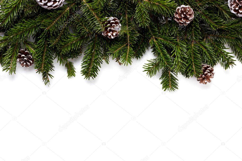Winter holidays background with fir tree branch and decorations covered in snow isolated frame