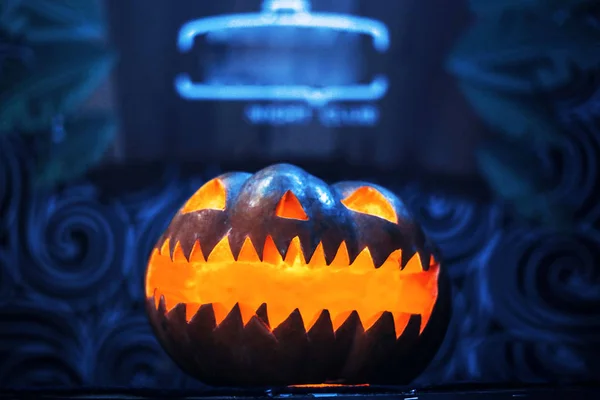 Carved scary pumpkin face on Halloween burns inside