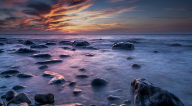 long exposure of sea and rocks on beach at sunset, Rgen island, Germany, Europe clipart