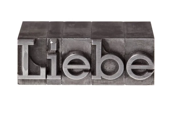 Letterpress Iron Lead Letters Forming German Word Love — Stock Photo, Image