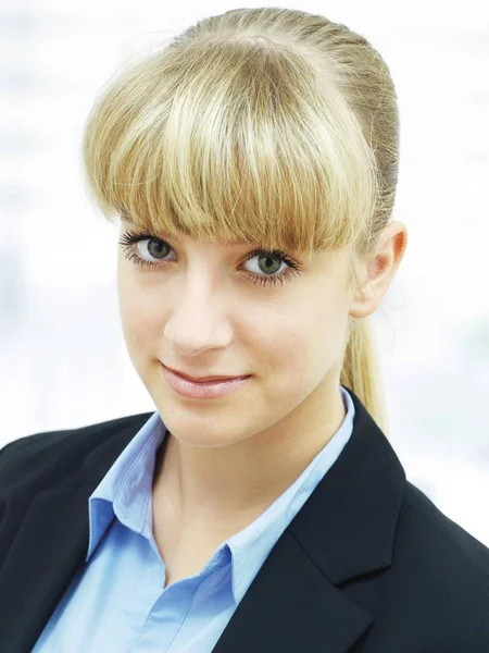 Businesswoman portrait, woman with blonde hair bang looking at camera
