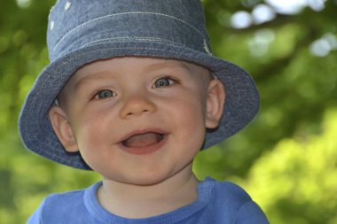 Smilng toddler with a hat, portrait, Germany, Europe clipart