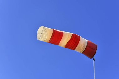 scenic view of Red and white windsock against a blue sky, Lilling, Middle Franconia, Bavaria, Germany, Europe clipart