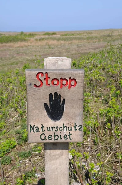 Wooden sign with stop on german language