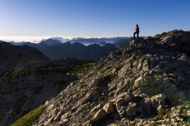 Peaks of the Allgau Alps in the early morning with a hiker, Oberstdorf, Bavaria, Germany, Europe clipart