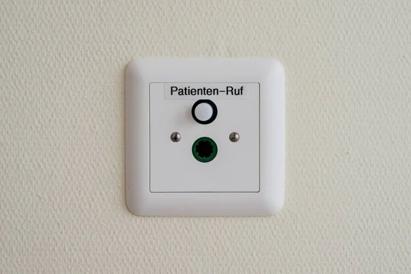 Patient call button on the wall in a German hospital, German language