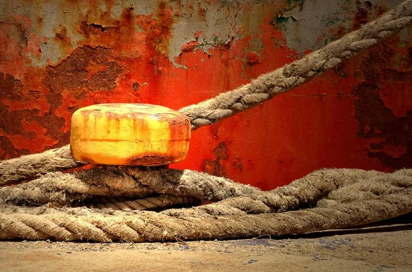 Yellow Bollard Ropes Wrapped Front Rusty Ship Hull Crete Greece — стоковое фото