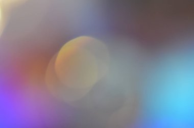 Glitter, defocused ile Cd disk üzerindeki lamba ışığında alınan doğal soyut renkli bokeh arka plan