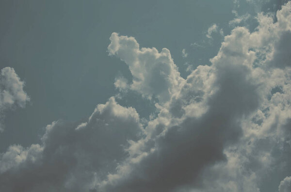 Nature background. Fluffy soft clouds in sky toned