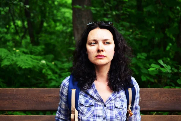 Traveling woman looking into the distance, outdoors. Girl thinking how to hike