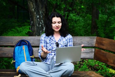Parkta dizüstü bilgisayar kullanan kadın seyahat. Serbest kavramı iş doğa üzerinde çalışma seyahat