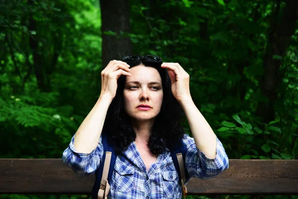 Traveling woman looking into the distance, outdoors. Girl thinking how to hike