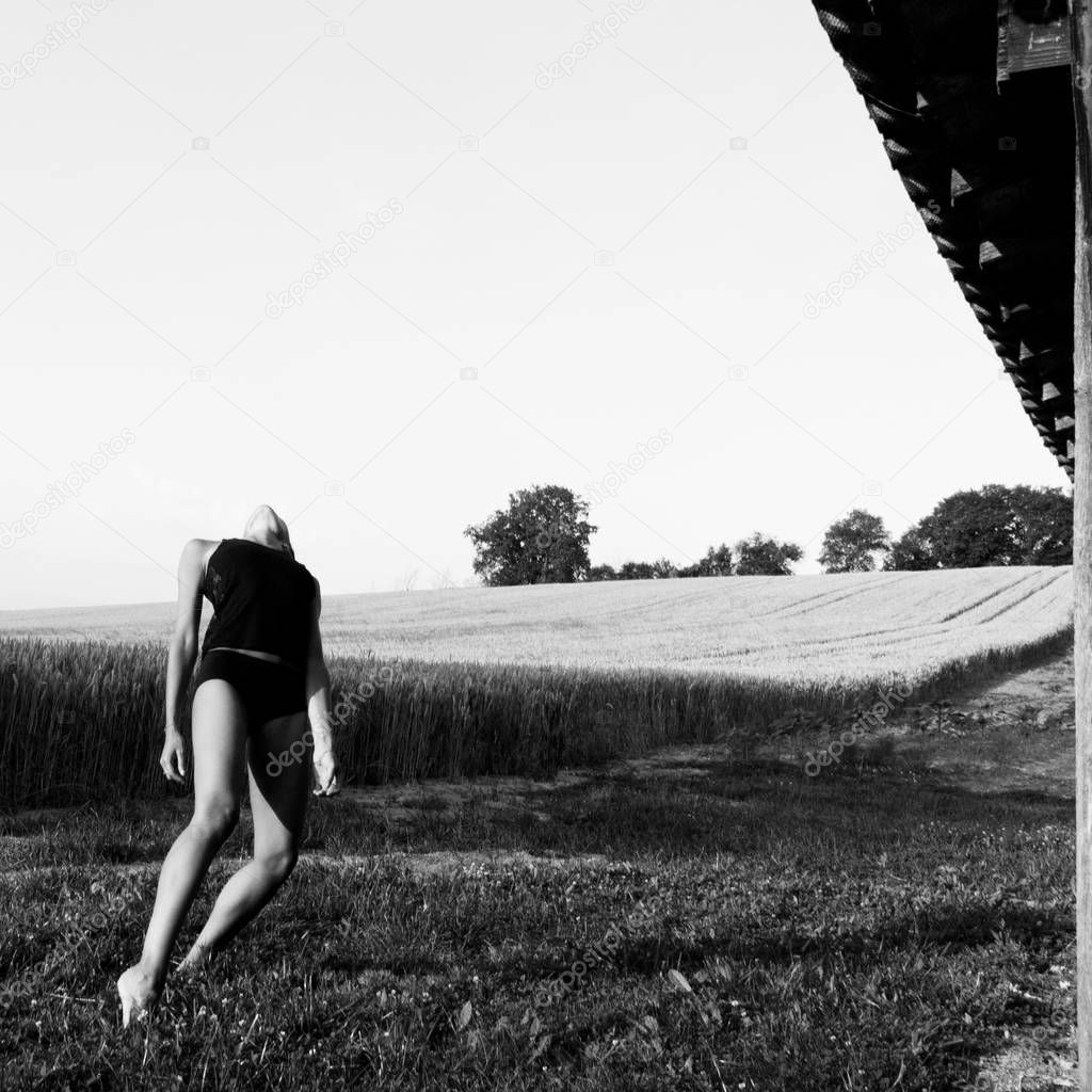 Imbalance, exercise in a field for a female dancer.