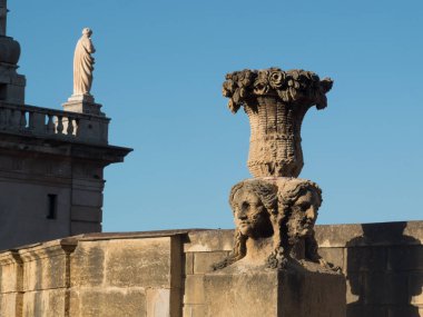 Palermo,Sicily, Italy-September 14,2016 : sculpture of antique vase with women's portraits on the Mura delle Cattive, a panoramic, sea-view promenade created in the 19th century atop the city's 16th century defensive walls.  clipart