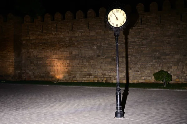Clock at night at the fortress walls of Baku