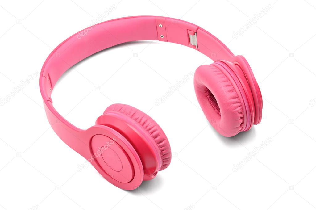 Pink headphones for listening to sound and music on a white back