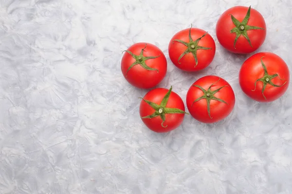 Red tomatoes on a marble background — Stock Photo, Image