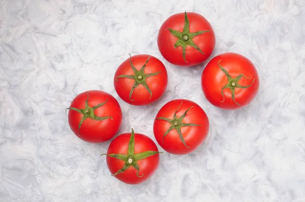 Red tomatoes on a marble background — Stock Photo, Image