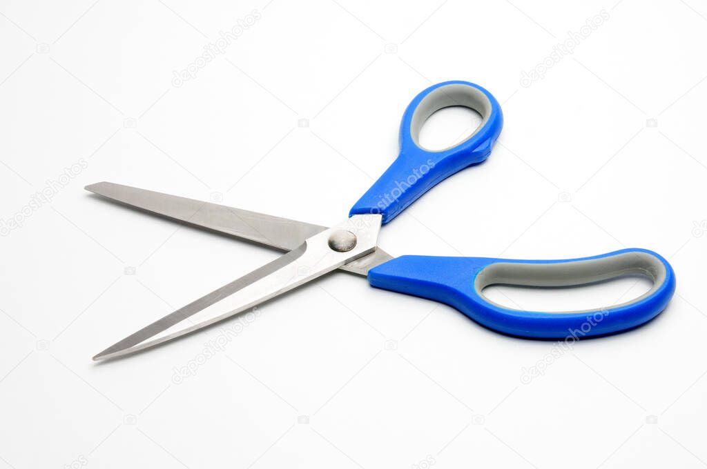 Scissors with a blue handle for tailors on an isolated white background