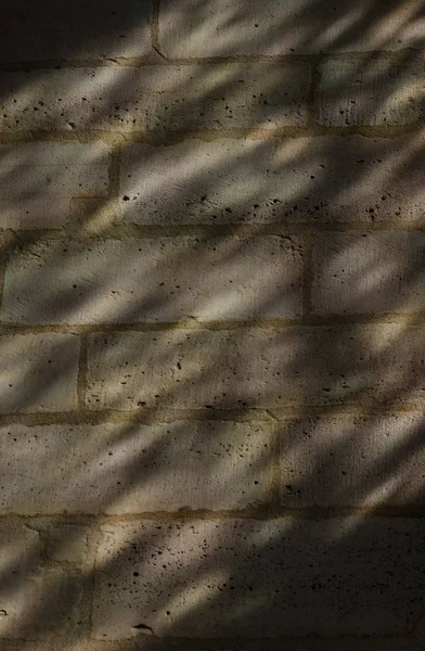 Lights and shadows on a stone wall made by stained glass